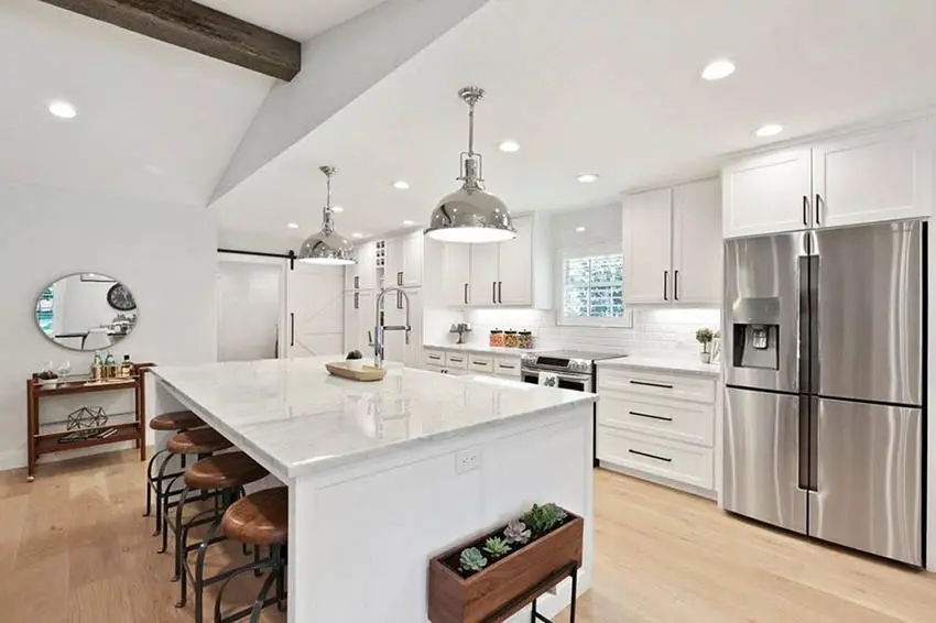 White cabinet kitchen with light color hardwood flooring