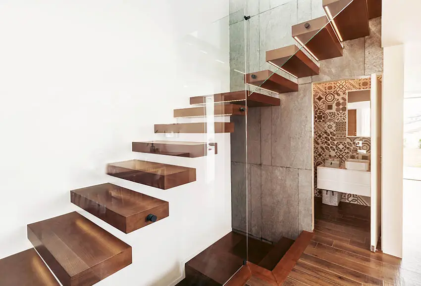 Wooden staircase treads with frameless clear glass rails