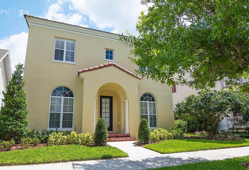 Yellow stucco home with French windows