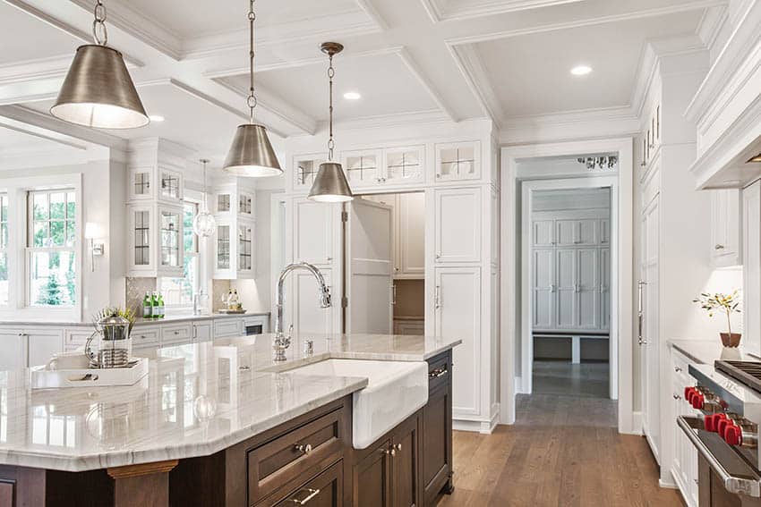 Beautiful traditional kitchen with single basin apron sink, marble countertop and dark wood island