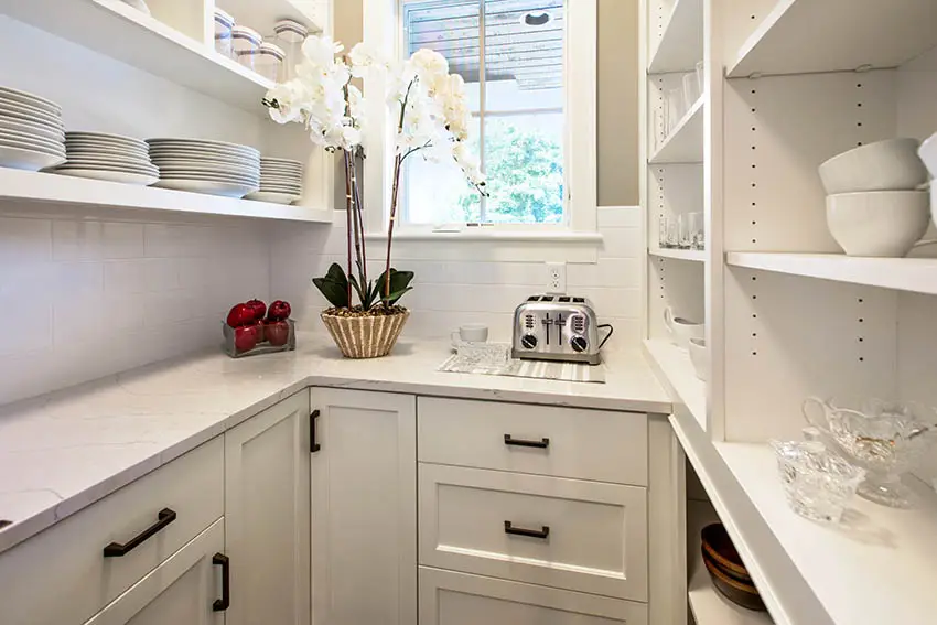 Kitchen pantry closet with white storage cabinets