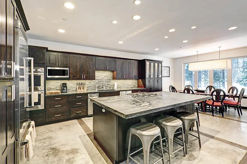 Kitchen with sintered stone countertops dark wood cabinets