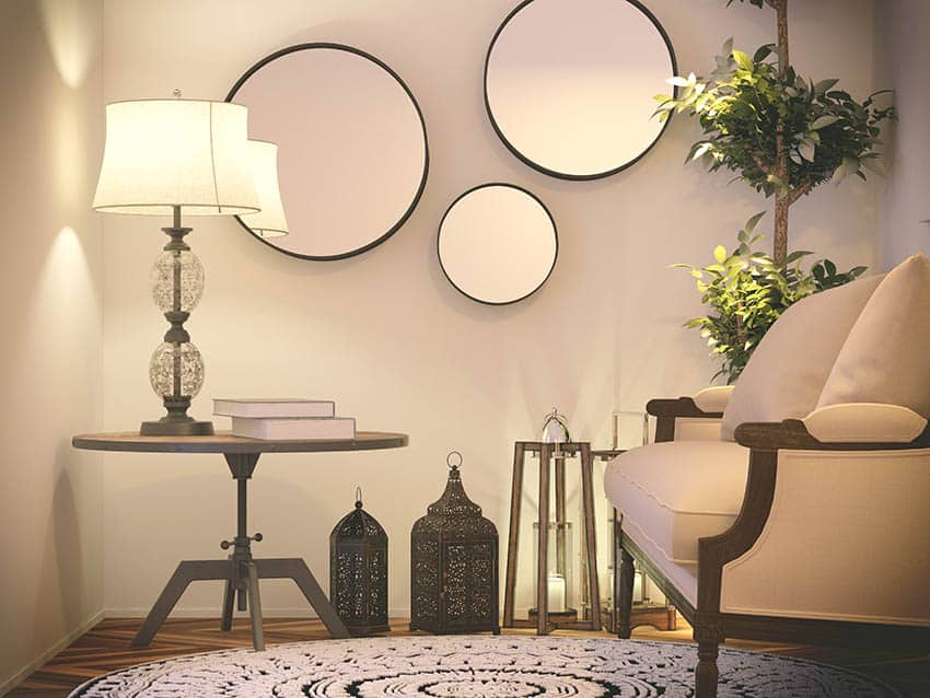 Living room with table lamp and wall mirrors