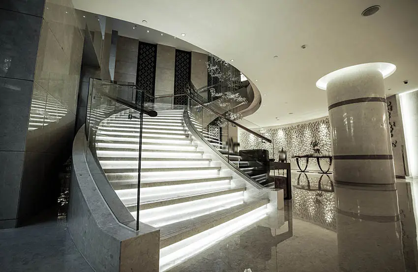 Luxury home with glass walled staircase and lighted steps