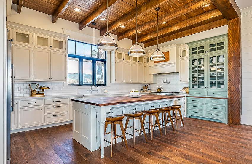 Modern french country style kitchen white cabinets, green side cabinet, butcher block island open beam ceiling