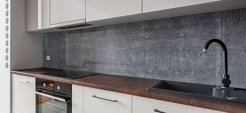 Kitchen concrete backsplash with brown stained concrete countertops