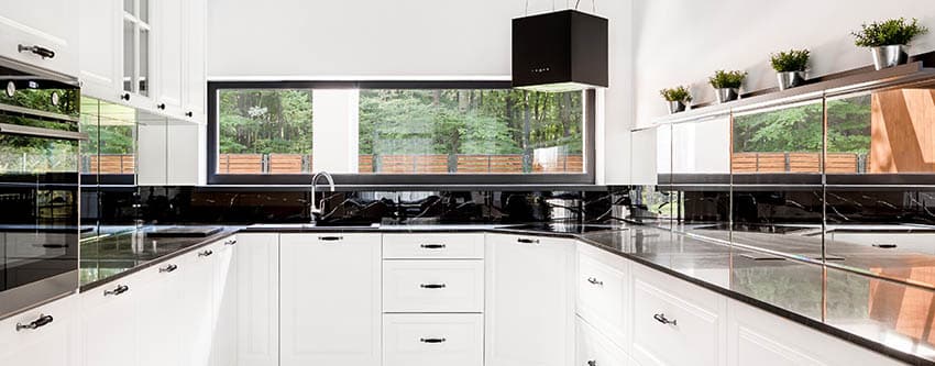 Modern kitchen mirror backsplash black countertops