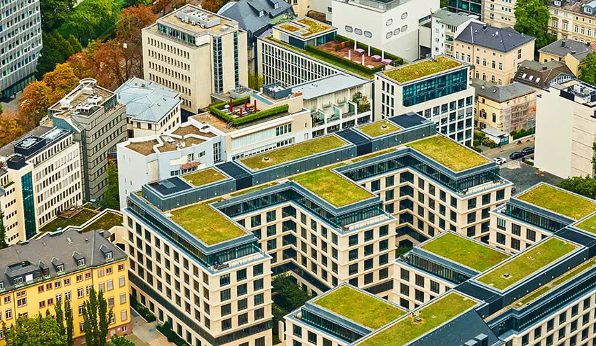 Apartment building with eco friendly green roof grass