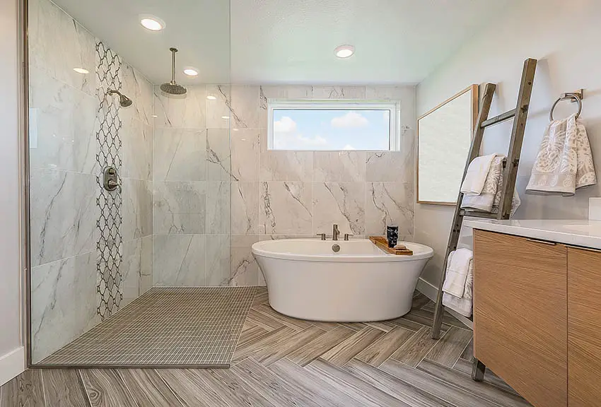 Bathroom with walk in shower freestanding tub and transom window