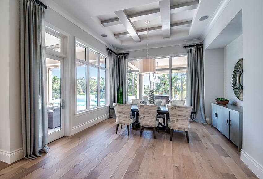 Beautiful dining room with light wood floors and gray paint