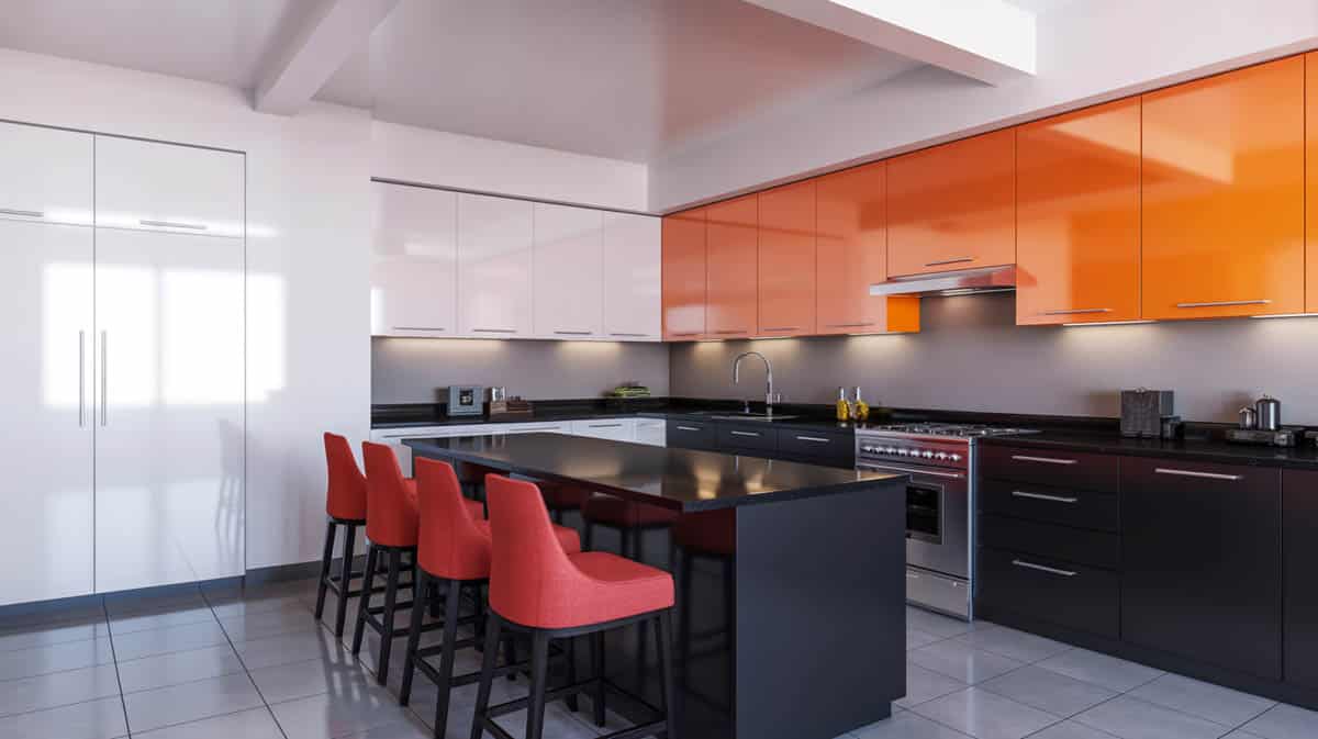 Bold kitchen with black lower cabinets, orange upper cabinets, white walls, and red bar stools
