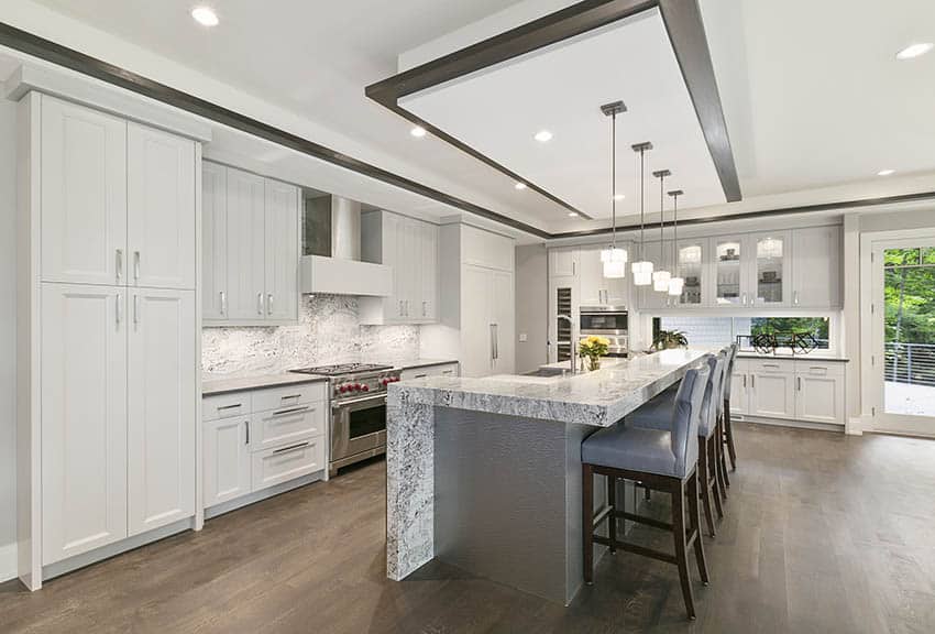 Kitchen with quartz as a backsplash, waterfall countertop island and open concept design