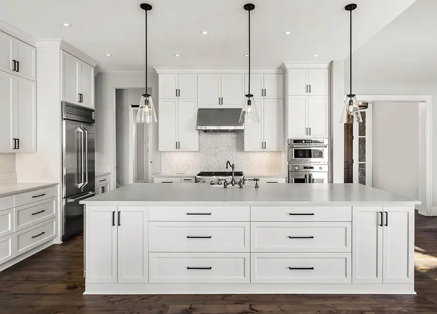 Contemporary kitchen with quartz tile backsplash countertops white cabinets wood flooring pendant lighting