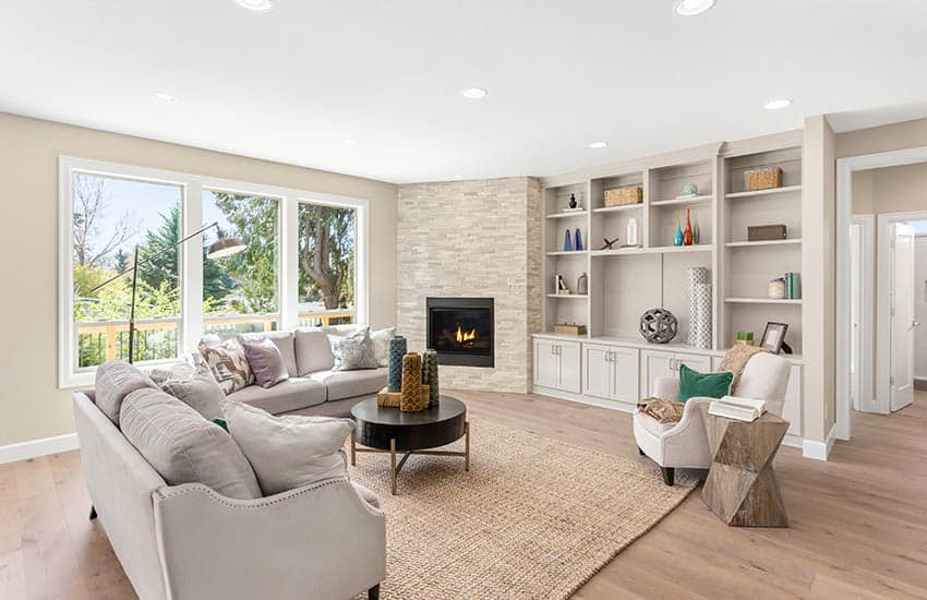 Room with light gray couch and built-in cabinets and fireplace