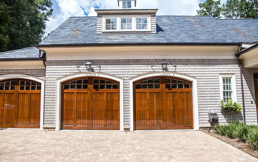 Custom 3 car garage with wood doors