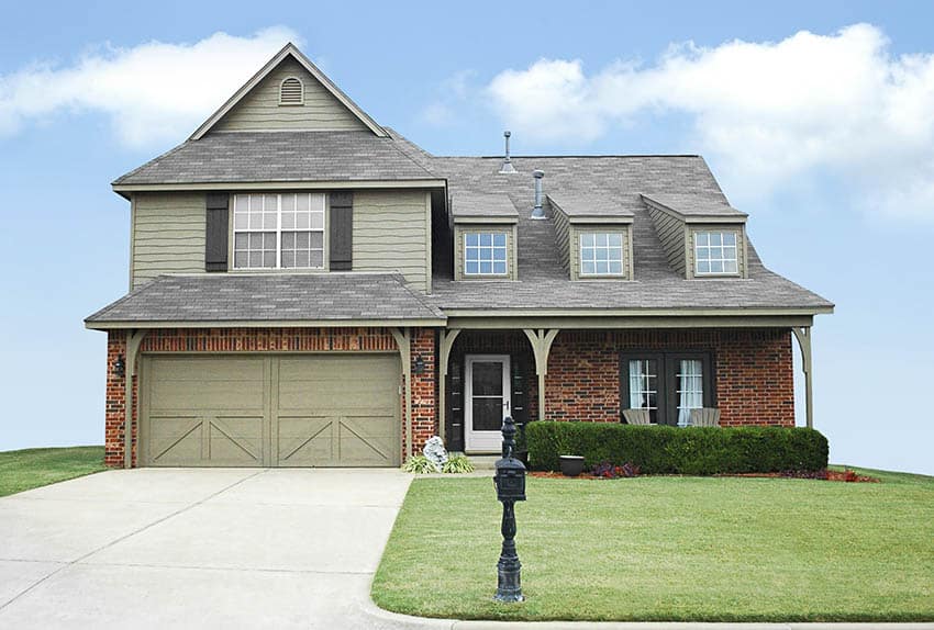 House exterior with brick and sage green 