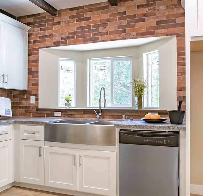 Kitchen bay window with brick wall open beam ceiling