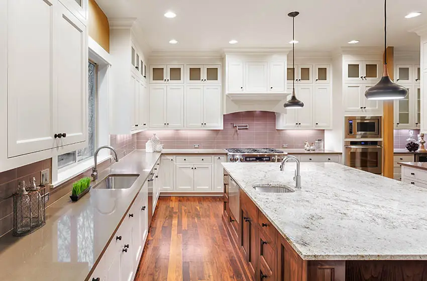 Kitchen with cabinet knobs two tone cabinets gray quartz marble countertops