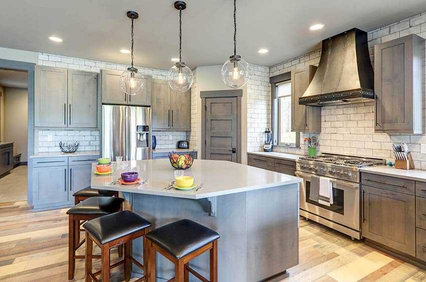 Kitchen with gray chalk paint cabinets and island with white quartz countertops