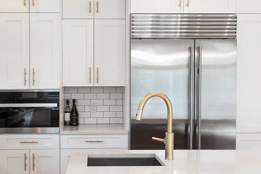 Kitchen with white cabinets gold hardware pulls