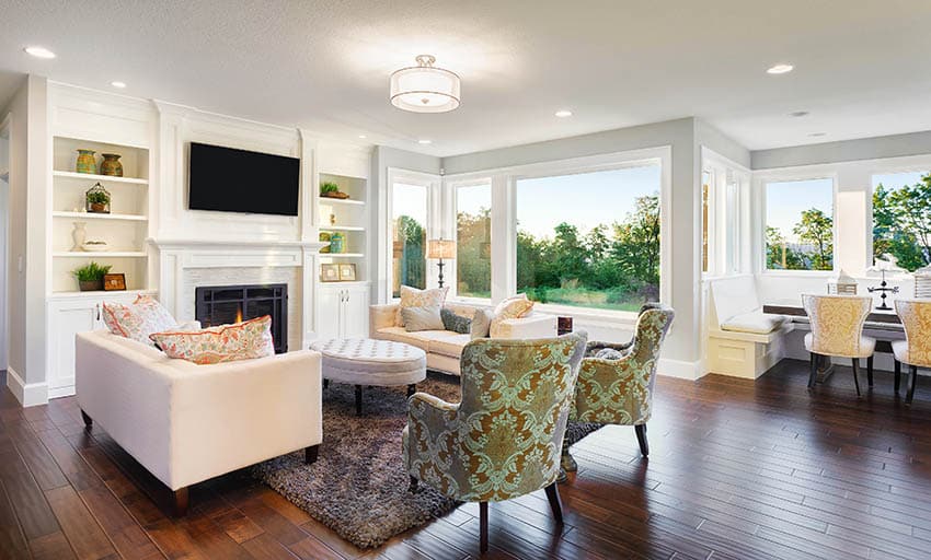 Living room with cherry wood floors light gray paint and white fireplace