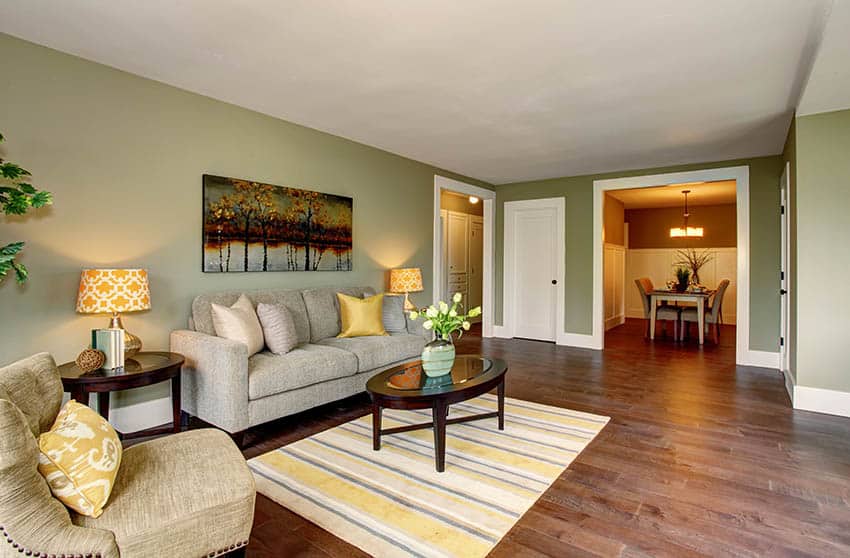 Living room with cherry wood floors sage paint