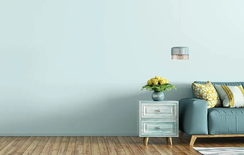 Oak flooring paired with pastel blue walls