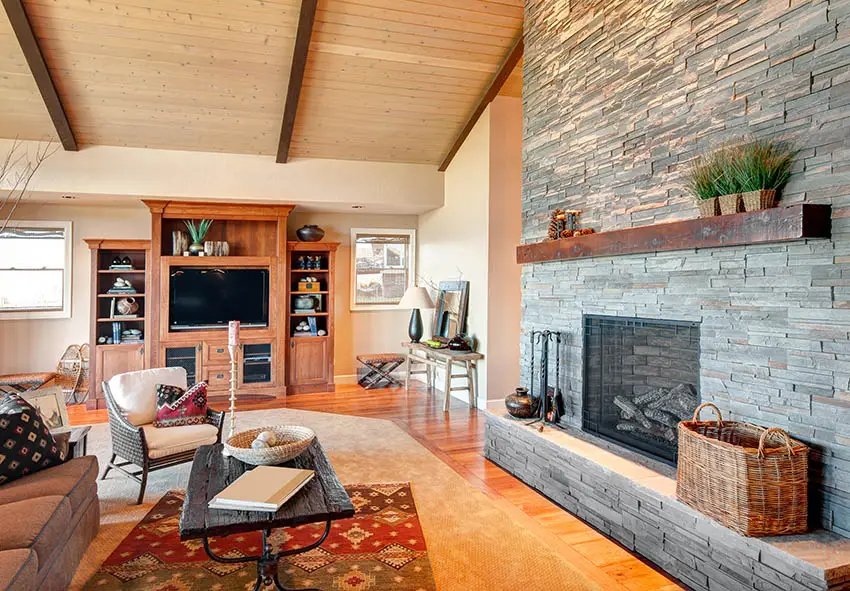 Living room with stacked stone fireplace and mahogany wood mantle