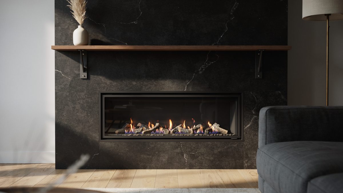 Black granite gas fireplace topped by a slim walnut shelf on steel brackets