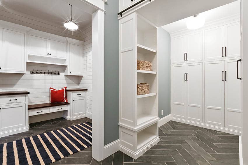 Mudroom addition with vinyl floor white cabinets small bench