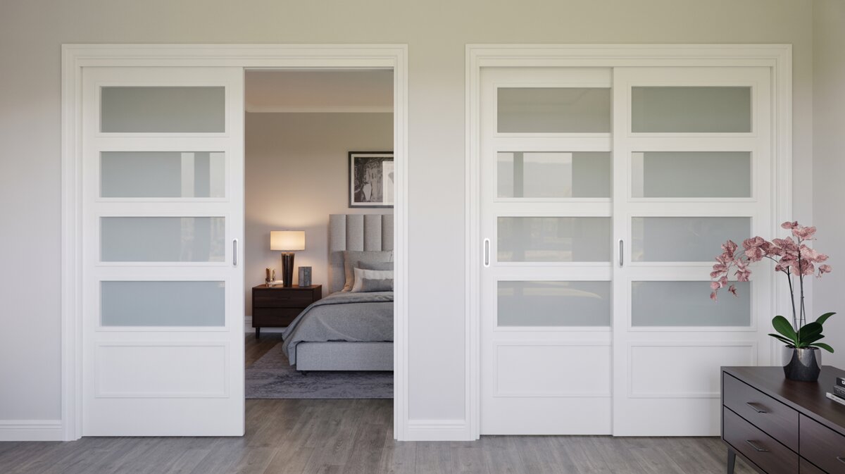 White framed double bypass sliding closet doors each with three frosted glass panels in a bedroom