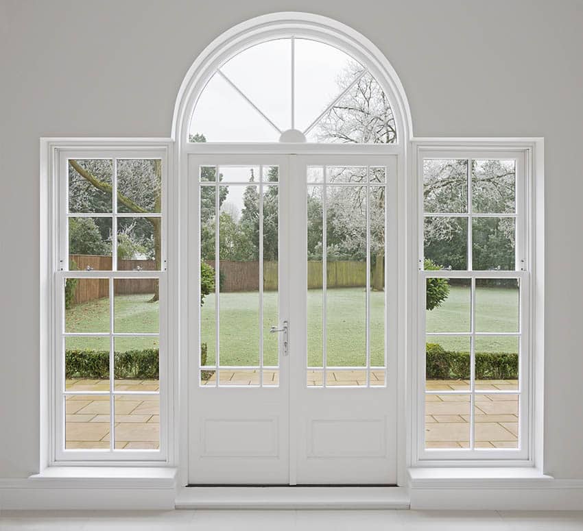 Arched front door with sidelights and transom window