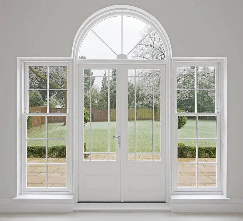 Arched front door with sidelights and transom window
