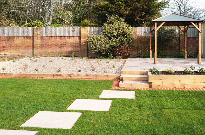 Backyard gravel landscape with pergola