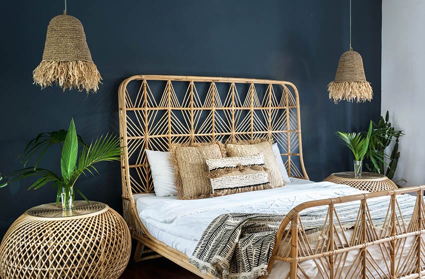 Bed with rattan headboard in bohemian design bedroom