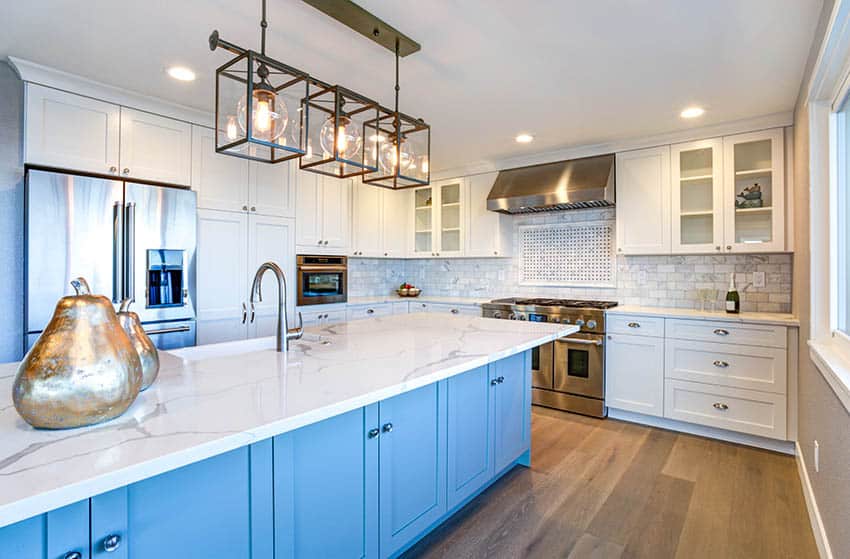 Coastal kitchen with white cabinets, blue island and quartz countertops