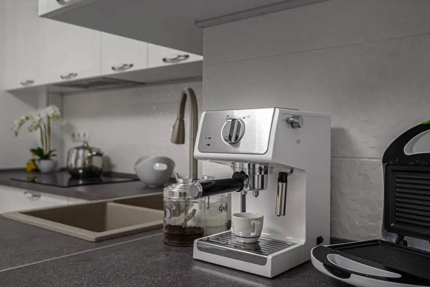 Coffee maker waffle maker countertop sink cabinets kitchen