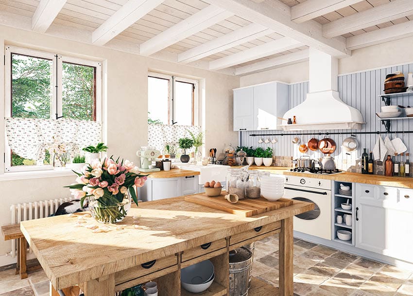 Eclectic kitchen with open shelves white painted beam ceiling raw wood table