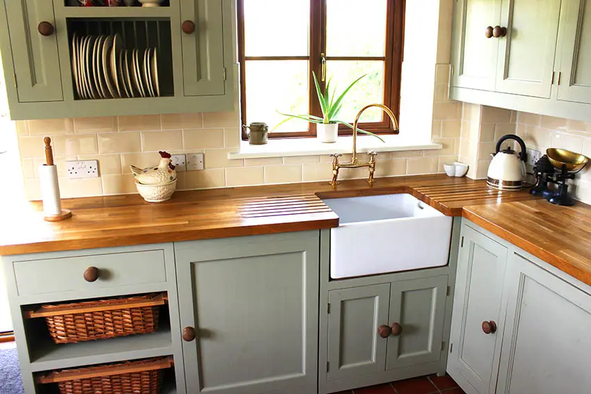 Farmhouse kitchen with butcher block countertops mint green cabinets open dish shelving