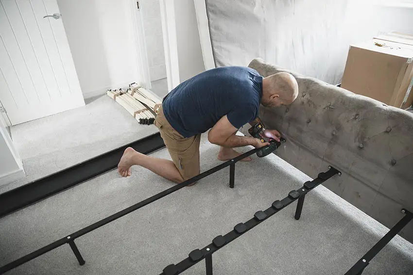 Man installing a headboard