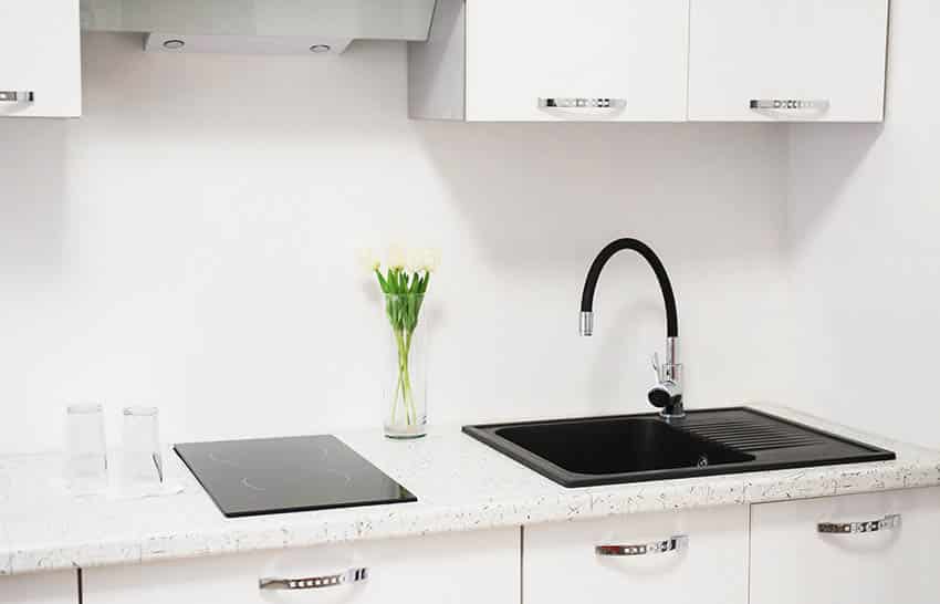 Kitchen with two burner ceramic drop in cooktop