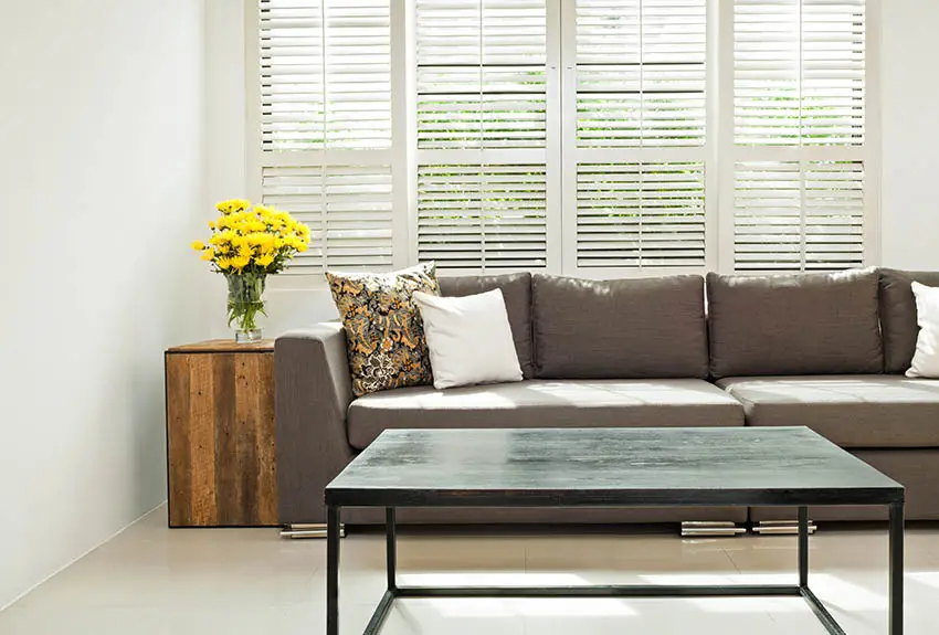 Living room with plantation shutters grey sofa