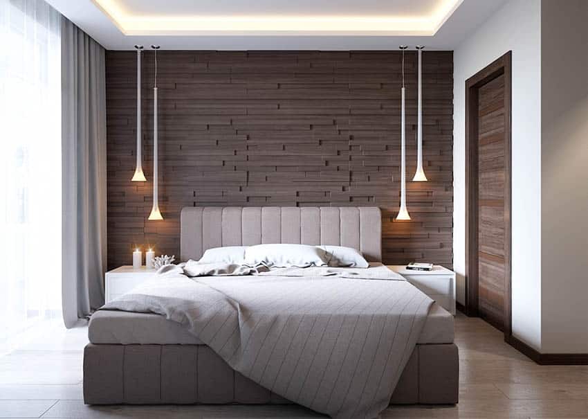 Bedroom with modern bed, padded headboard, wood accent wall, windows, curtain, nightstands, and hanging lights