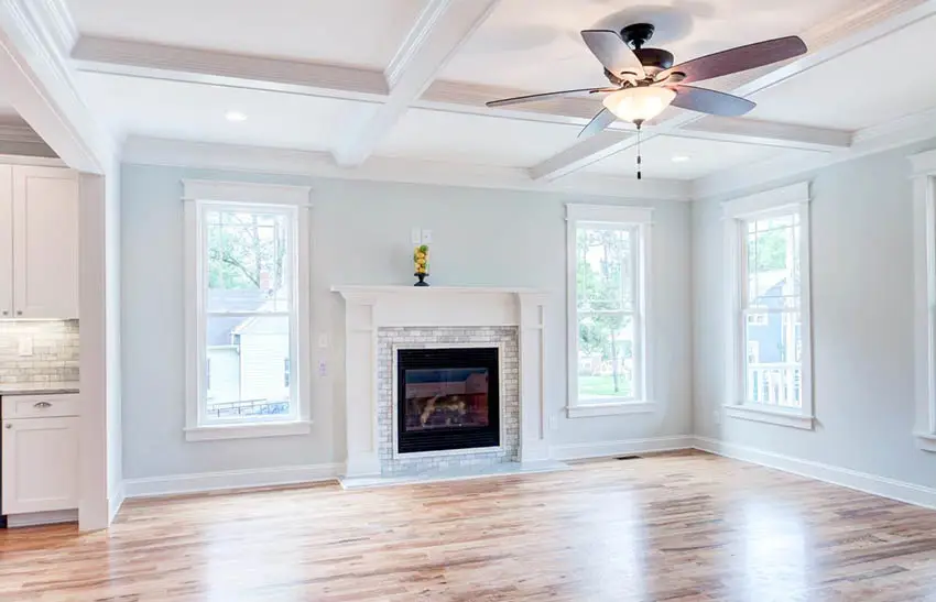 Southern home great room design with white molding fireplace surround coffered ceiling
