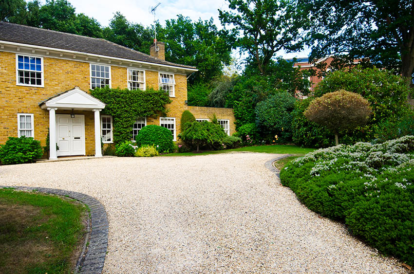 Traditional estate gravel driveway with brick border