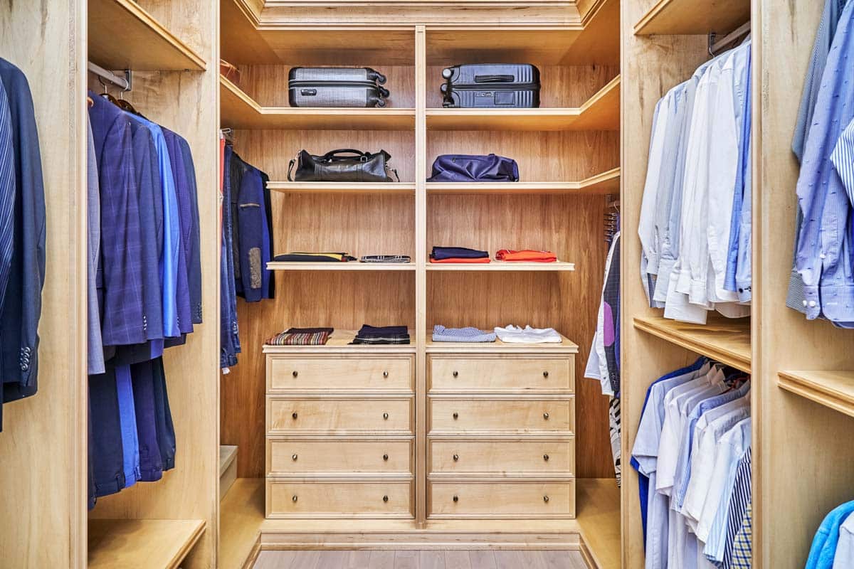 walk in closet with wood shelves and drawers