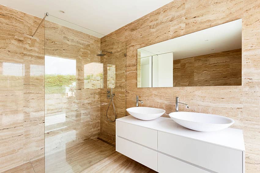Wet room bathroom shower with beige marble tile flooring walls