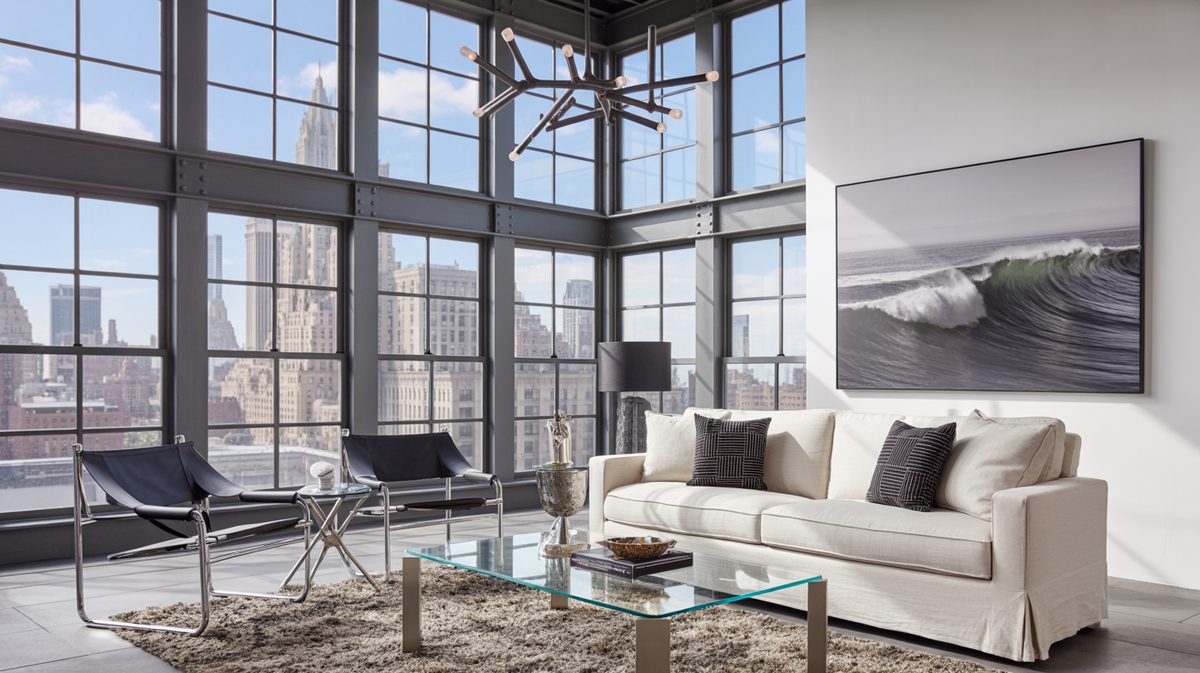 Manhattan loft masculine living room with steel and glass grid windows, sweeping city skyline view, and oversized wave photograph