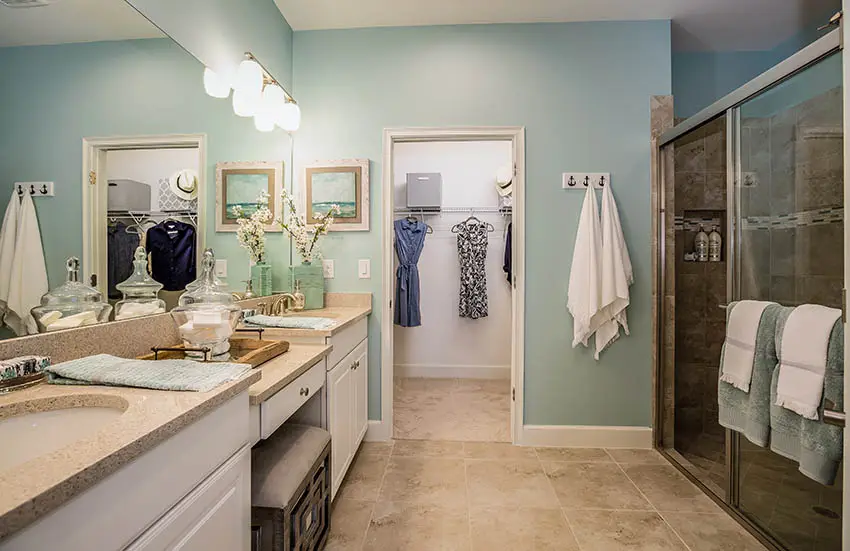 Bathroom with beige granite look solid surface countertops aqua blue paint