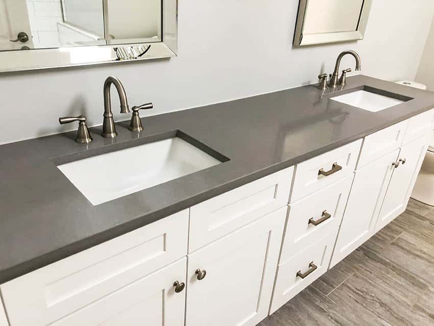 Bathroom with double sink vanity with brass finish faucets